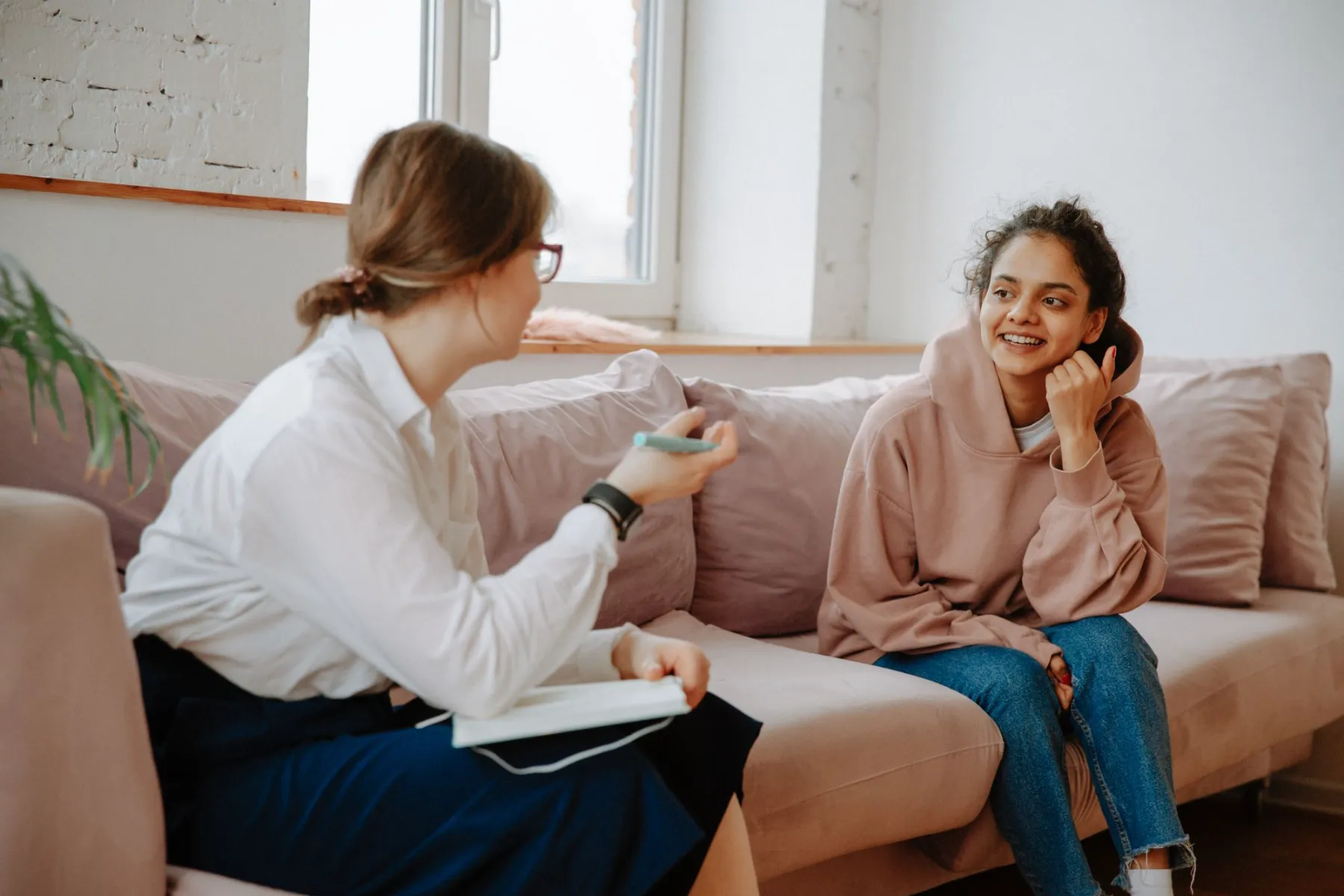 A counsellor listening to a client in a calm room